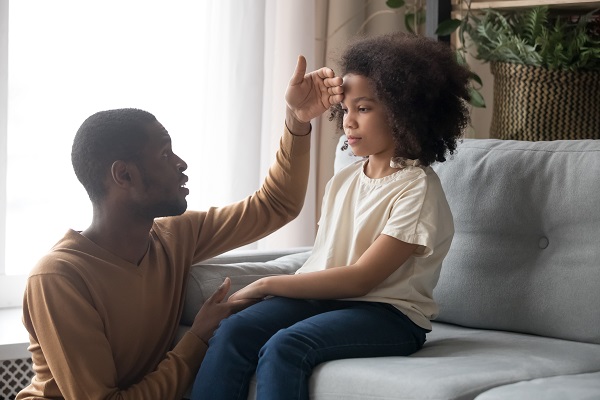 Concerned father touching his childs head