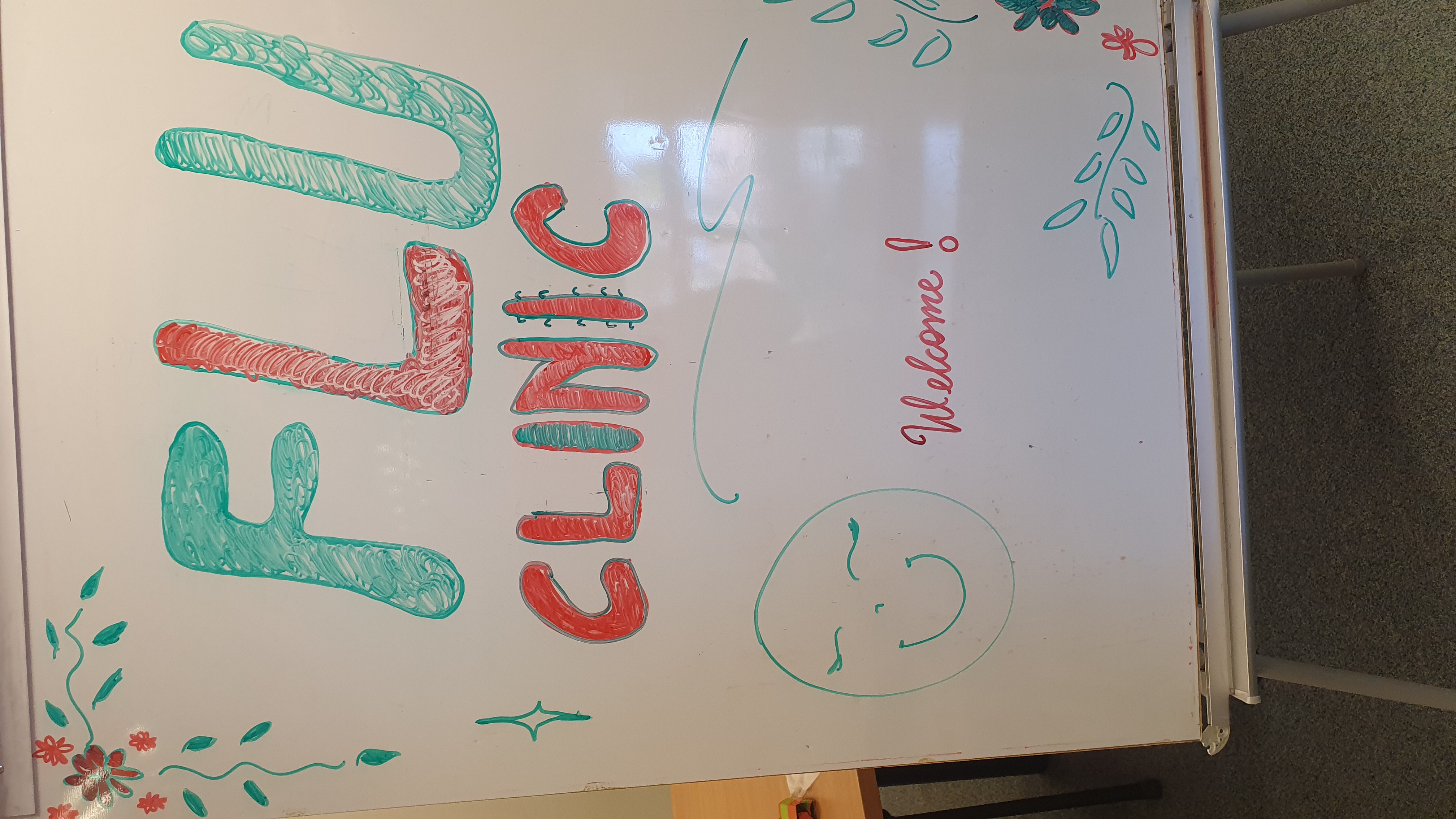 Whiteboard in the surgery reading Flu clinic with a smiley face